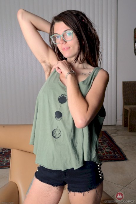 Nerdy brunette Valkyree Jaine spreading her very hairy pussy wide open