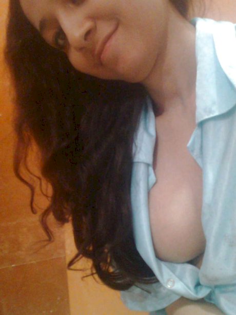 Indian solo girl holds her face firm while letting nipples free of lingerie