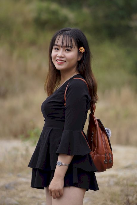 Gorgeous Asian babe posing in her black dress and boots in nature
