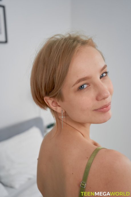 Pretty tattooed teen Tea Mint exposes her slim body and rubs her clit