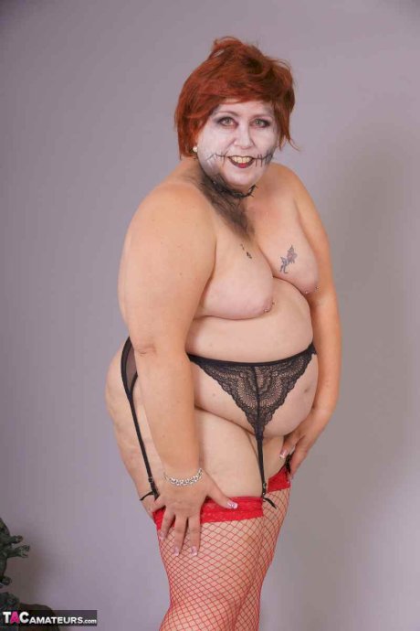 Redheaded BBW Lexie Cummings doffs cosplay wear to pose nude in mesh nylons