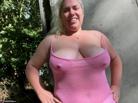Thick blonde Barby bares her saggy boobs and bald cunt in a rural location