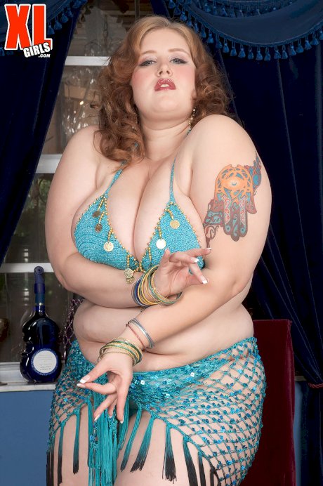 Fat female Miss Isabelle draws on a hookah pipe while taking off her bikini