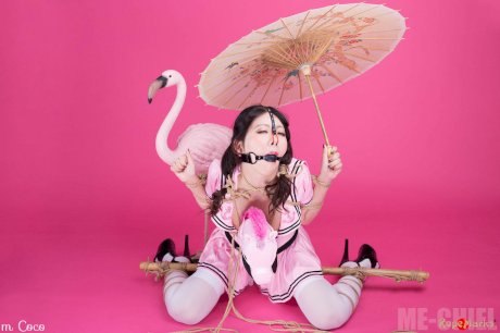 Asian solo girl Coco holds a parasol after being bound and ball gagged