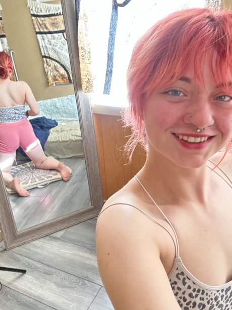 Pink-haired amateur slut Redhead Abby poses dressed up in the mirror