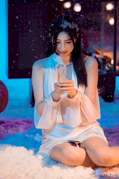 Sweet Asian babe Li Er shows off her big tits and gets banged from behind porn pics