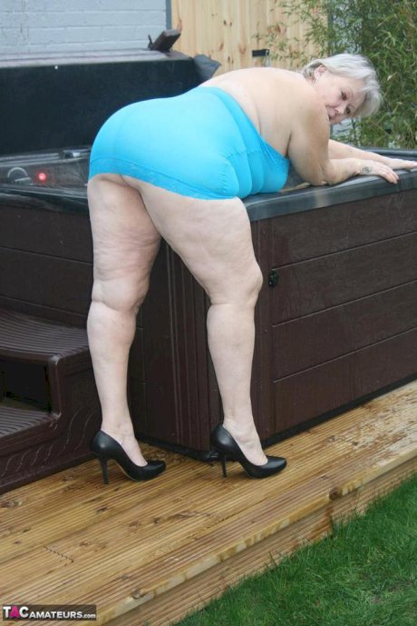 Fat granny hikes up see thru dress to expose her vagina in black pumps