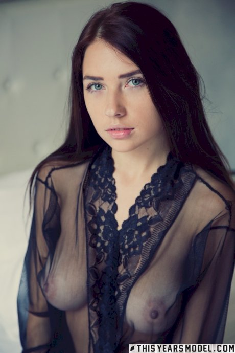 Gorgeous brunette Niemira removes sheer lingerie to stand naked on a bed