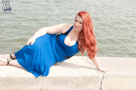 Redhead BBW Amerie Thomas runs water over her big tits after modeling a dress