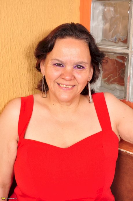 Overweight Latin housewife takes off red dress to pose in lingerie and hose