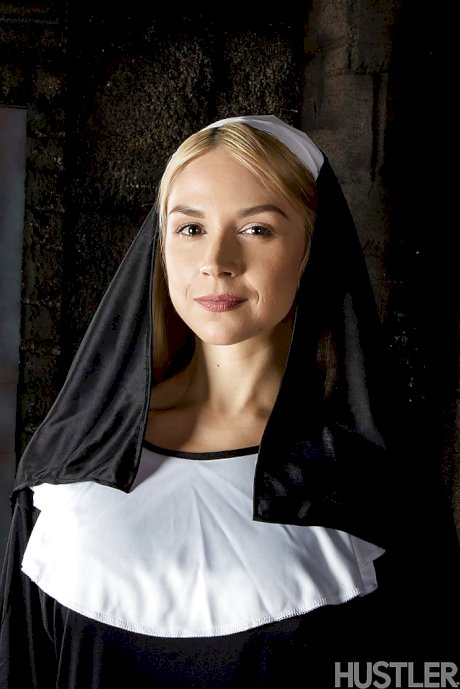 Blonde babe Sara Sloane strips off nun's uniform to expose big tits