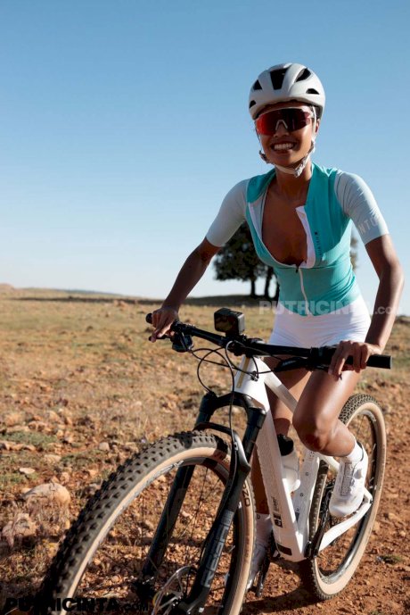 Petite Indonesian cyclist Putri Cinta strips while showing her tits outdoors - Photo 20