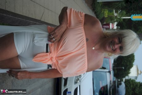 Mature British woman Denise Davies likes flashing her saggy tits in public