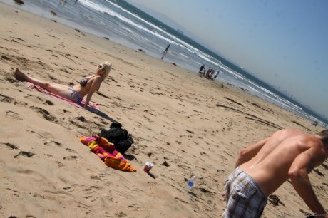 Chubby blonde sunbather Siri flaunts her big tits in a bikini on the beach