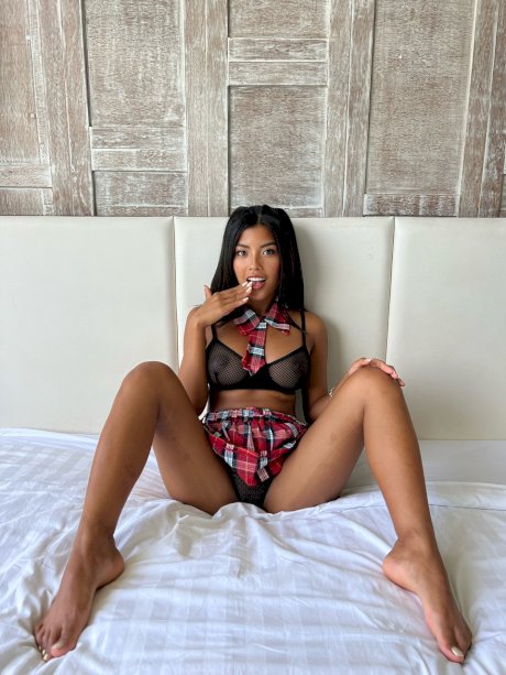 OnlyFans babe Tita Sahara poses in her schoolgirl outfit & unveils her boobs