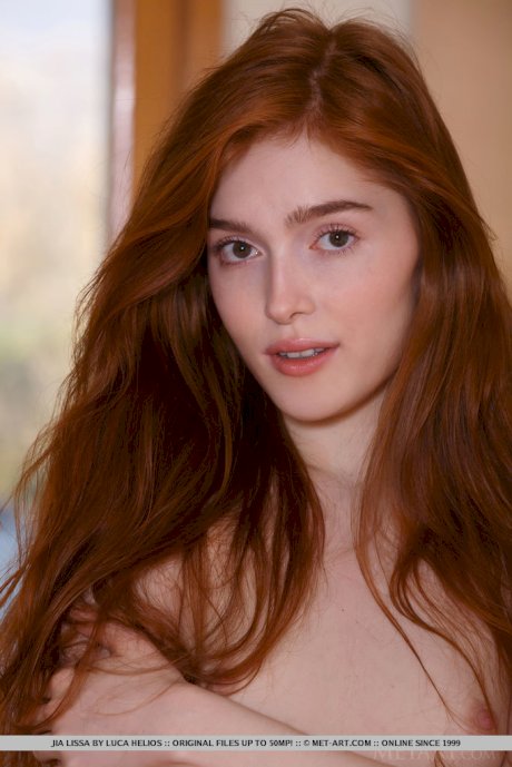 Redhead teen Jia Lissa shows her landing strip pussy in fetish clothing