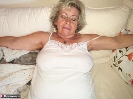 Horny grandmother slides hands down pantyhose to masturbate