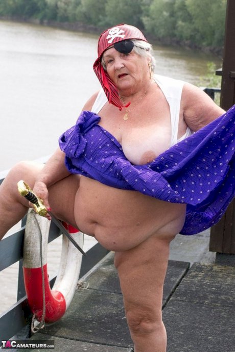 Fat British granny exposes herself on a bridge while sporting pirate attire