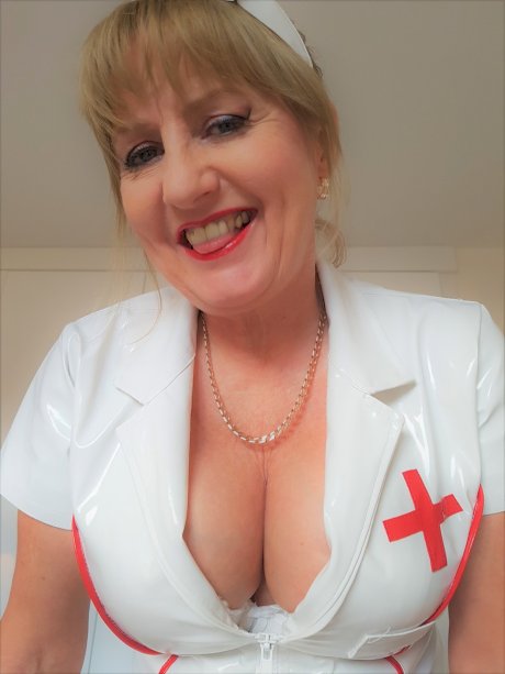 Mature nurse Lorna Blu displays her big ass and big cleavage in a solo