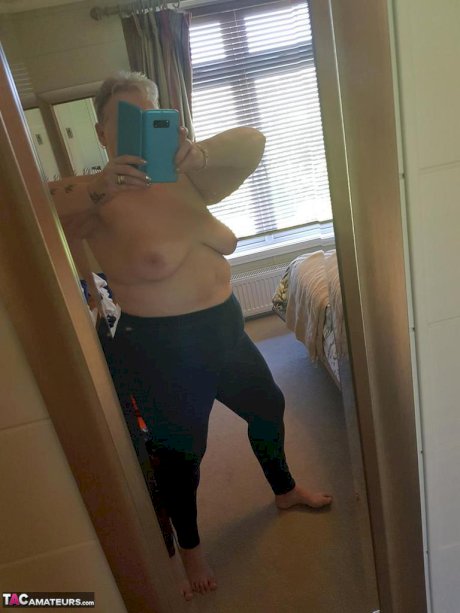 Fat granny with red hair Valgasmic Exposed takes naked selfies at home