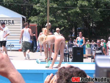 Candid behind-the-scenes action during a stripshow at a clothing optional club