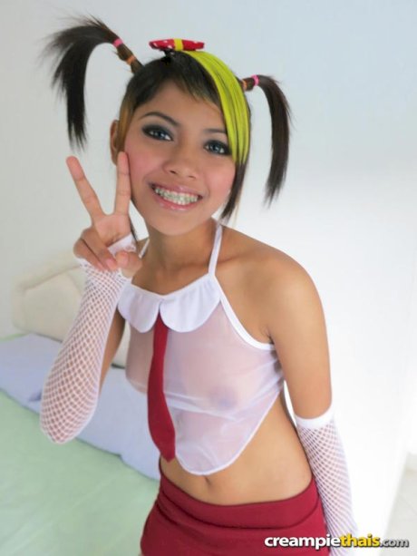 Cute Thai girl in pigtails poses nude in mesh arm socks and stockings