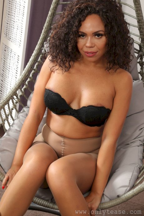 Curly haired bombshell Natalie B shows her stacked body wearing pantyhose