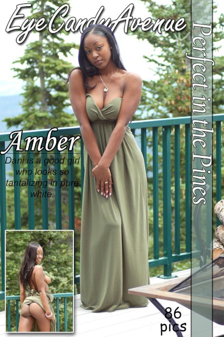 Ebony amateur Amber releases her big tits from a long dress on a balcony