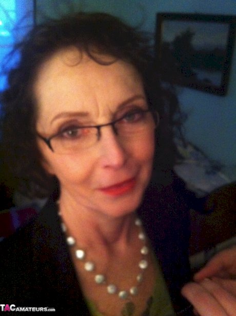 Curly haired mature woman likes sending her younger partner provocative photos