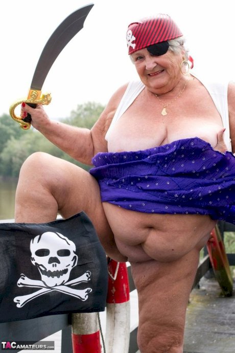 Fat British granny exposes herself on a bridge while sporting pirate attire