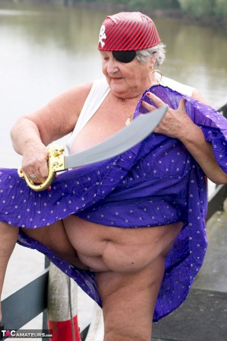 Fat British granny exposes herself on a bridge while sporting pirate attire