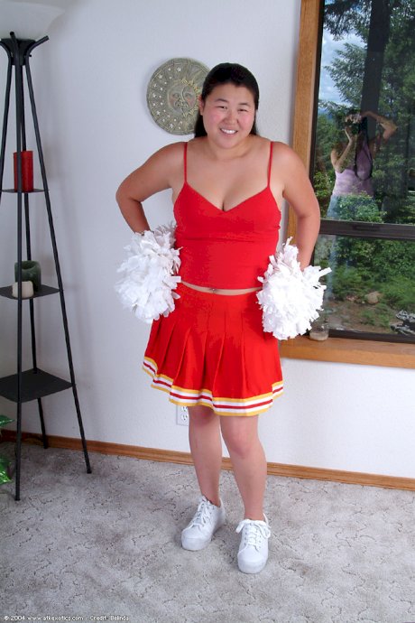 Chubby Asian first timer baring small boobs while shedding cheer uniform