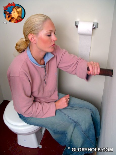 Blonde girl Jamie sits on the toilet and blows a black gloryhole dong