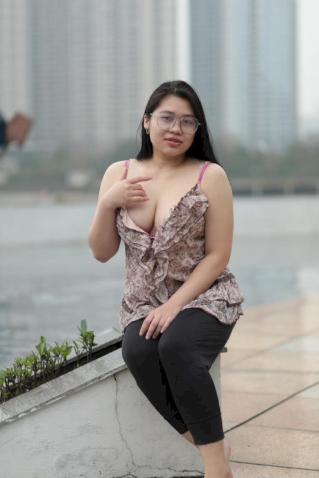 Beautiful chubby babe in glasses teases with her big boobs outdoors