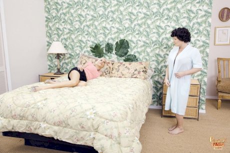 Hot older woman and her younger lover kiss after having lesbian sex on a bed - Photo 1