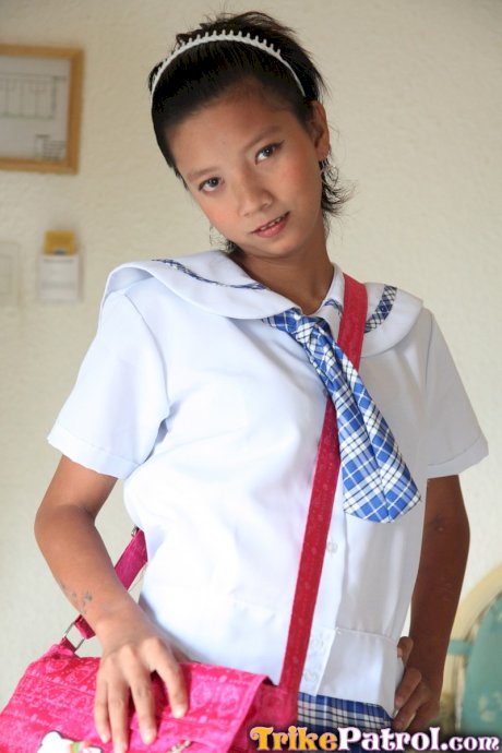 Adorable Asian schoolgirl Sally slides her cute panties aside to show her twat