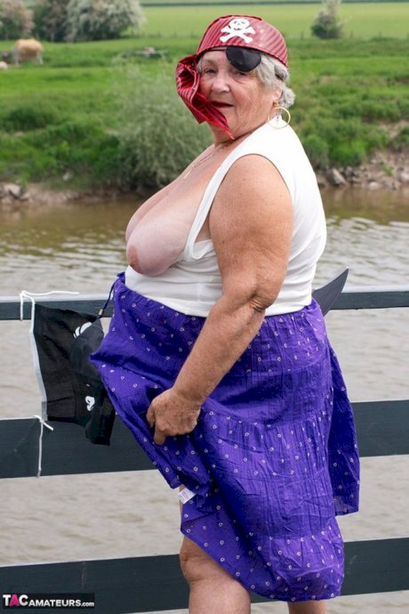 Fat British granny exposes herself on a bridge while sporting pirate attire