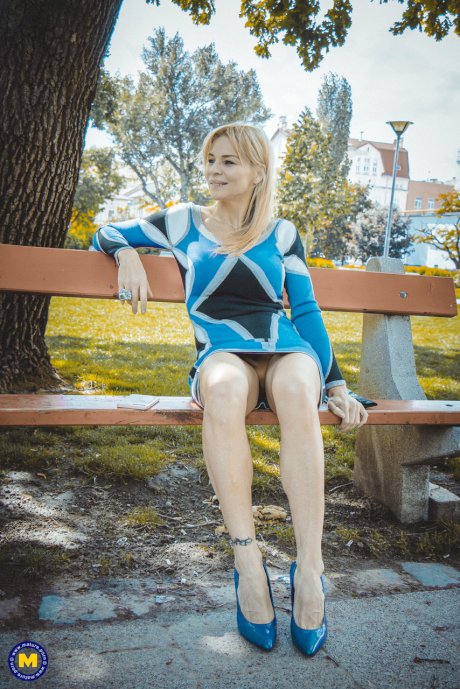Mature blonde Nadya Basinger teasing with her hot legs in a short blue dress