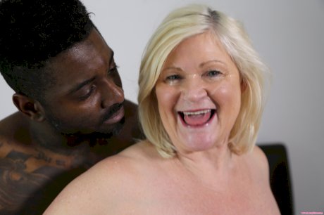 Chubby blonde granny Lacey Starr tastes a black cock before riding it