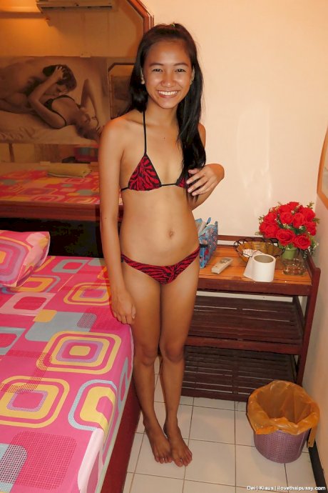 Petite Thai bar maid removing bikini to expose smooth pussy