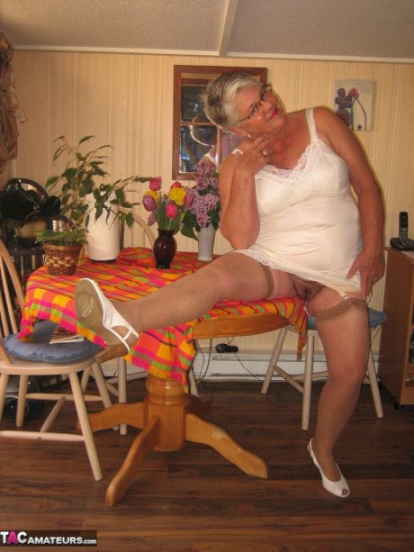 Fat granny Girdle Goddess exposes her huge boobs in a girdle and nylons