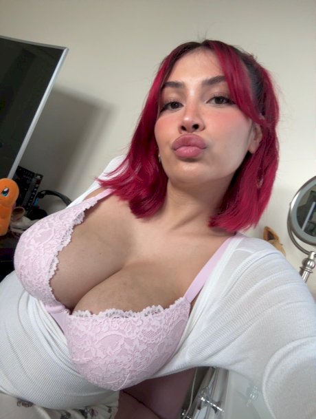 Buxom redhead Angel displays her big boobs up close in a sexy compilation