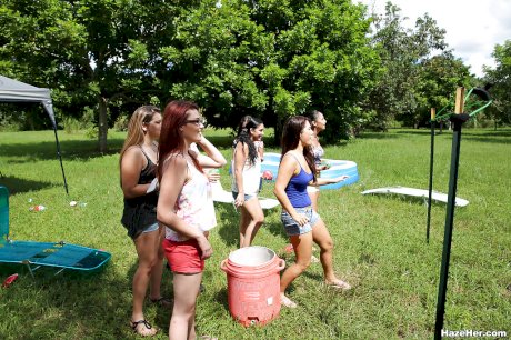 Pretty naked lesbians are standing naked and showing their bodies outdoor