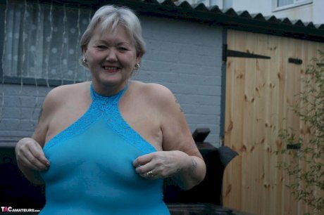 Fat granny hikes up see thru dress to expose her vagina in black pumps