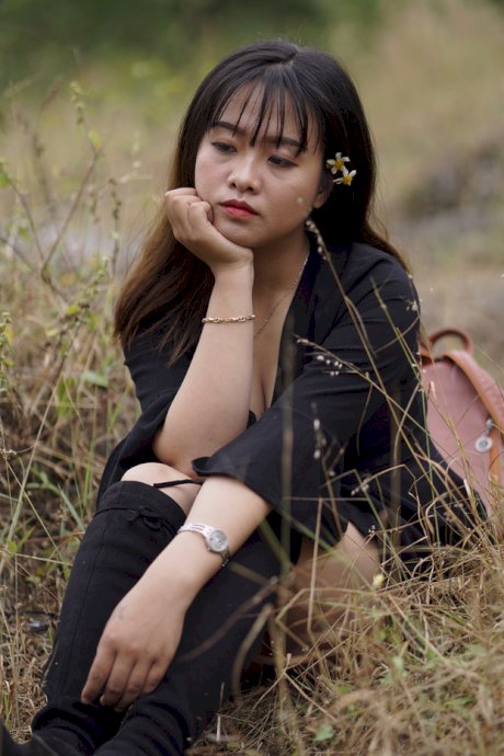 Gorgeous Asian babe posing in her black dress and boots in nature