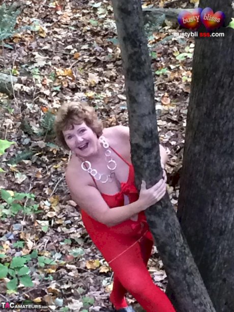 Older lady Busty Bliss gets completely naked while in a forest