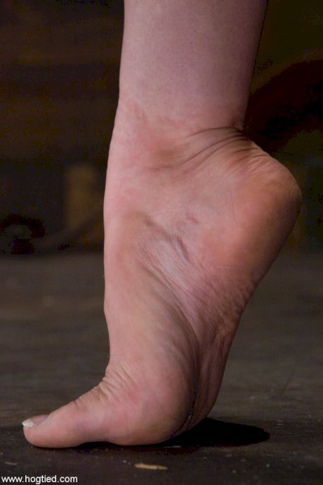 Naked female is masturbated while suspended by rope in a dungeon - Photo 2