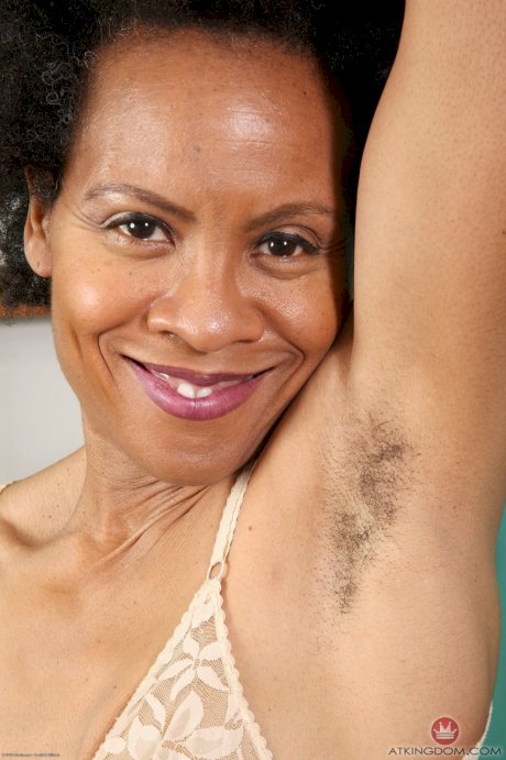 Older black lady takes off her glasses before exposing her unshaven body