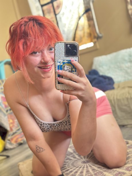 Pink-haired amateur slut Redhead Abby poses dressed up in the mirror