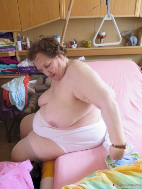 Chubby granny Aloysia plays with her saggy tits while undressing